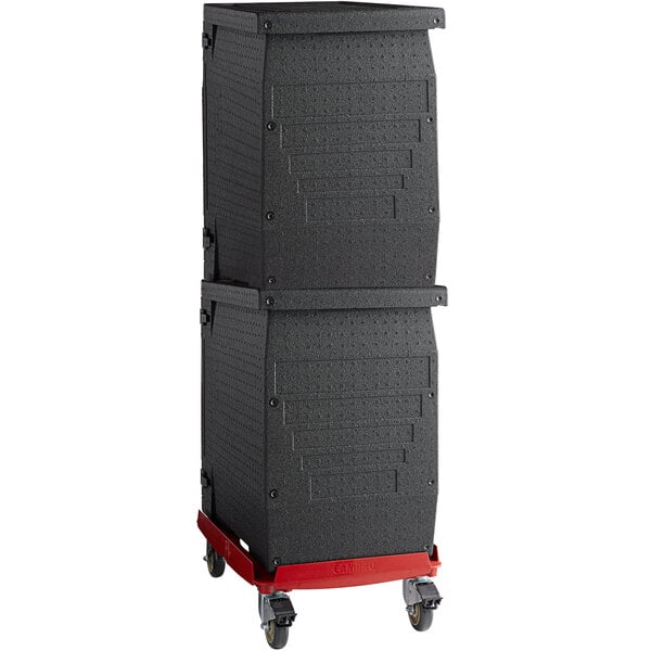 A black rectangular Cambro EPP pan carrier kit on a red Camdolly with wheels.