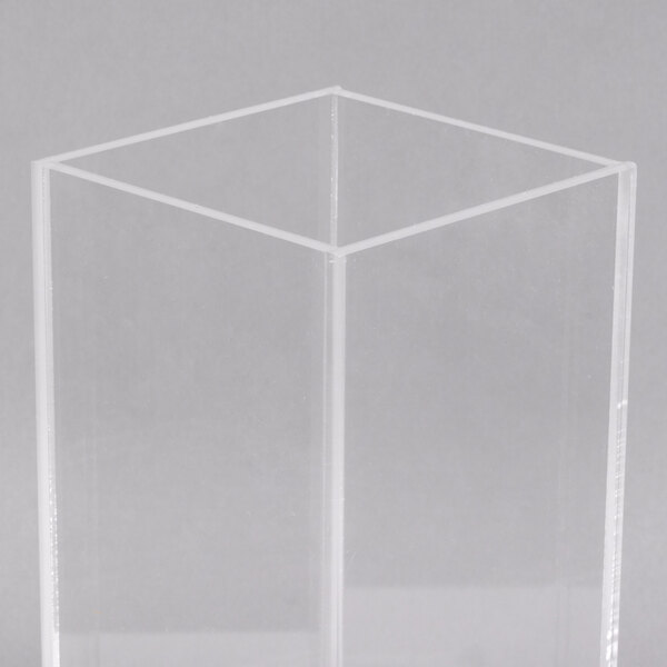 A clear plastic box with a square base.