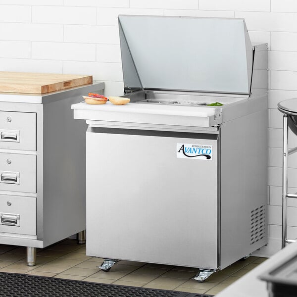 An Avantco stainless steel refrigerator with a lid open.