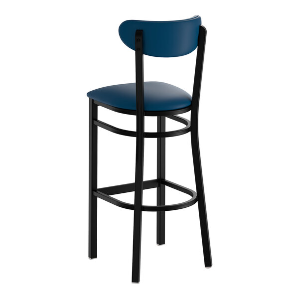 A bar stool with a black frame and navy vinyl seat and backrest.