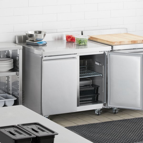 An Avantco stainless steel worktop refrigerator in a professional kitchen.
