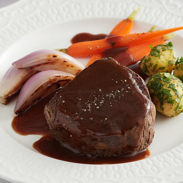 A plate of food with Knorr Ultimate Demi Glace sauce and vegetables.