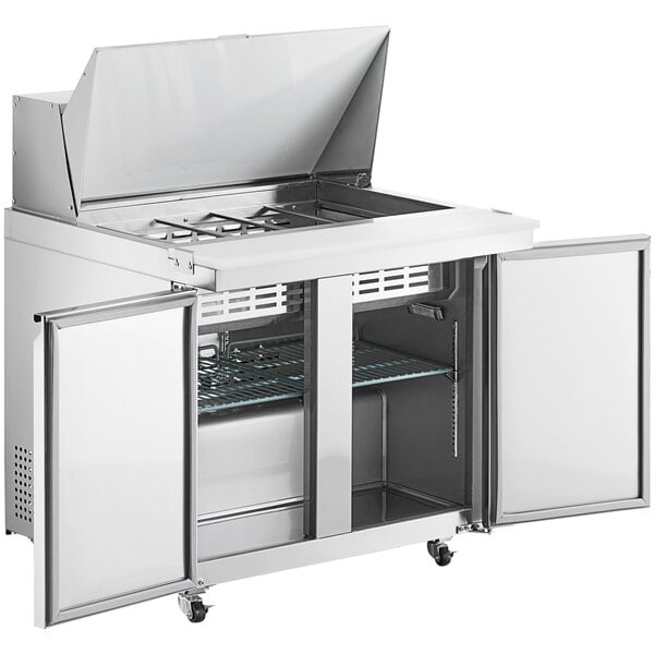 An Avantco stainless steel double door refrigerator with a lid open.