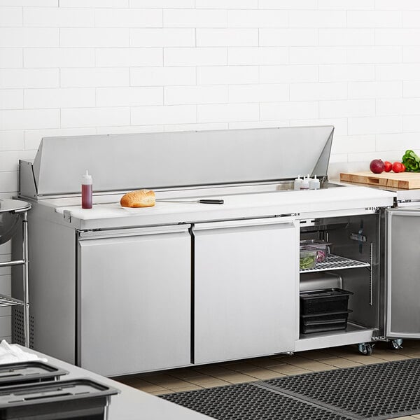 An Avantco stainless steel refrigerator on a kitchen counter.