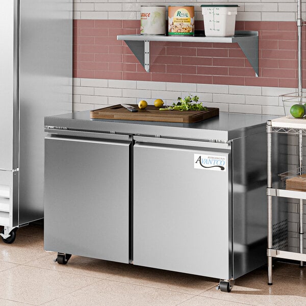 An Avantco stainless steel undercounter freezer on a kitchen counter.