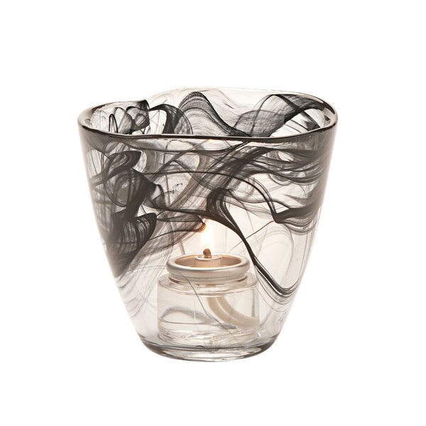 A black glass Hollowick Wysp votive with a lit candle inside.