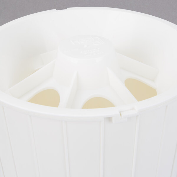 A white plastic Prince Castle Ketchup Collector with holes.