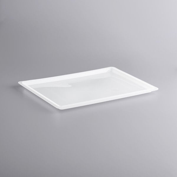 A white rectangular plastic lid on a gray background.
