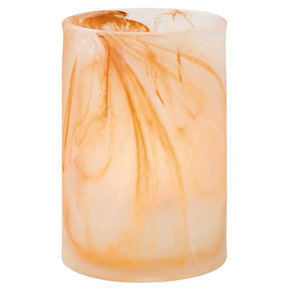 A close up of a Hollowick Caramel Glass Cylinder Lamp with a lit candle inside with a swirl pattern.