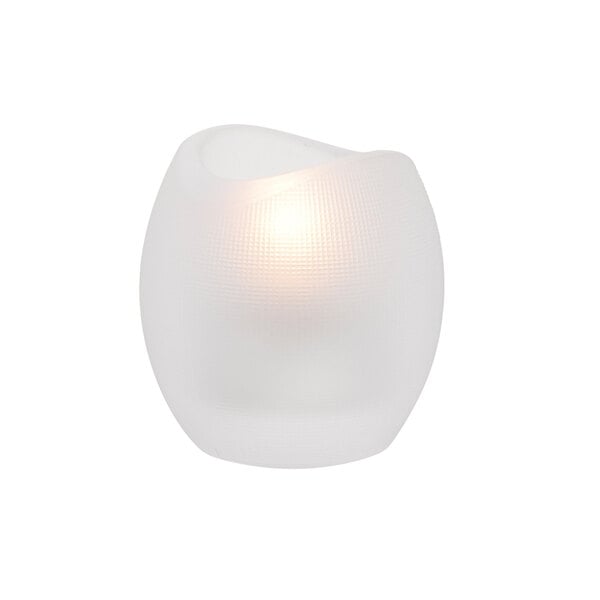 A white crystal glass tealight holder with a lit candle inside.