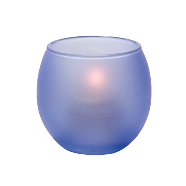 a blue candle holder with a lit candle