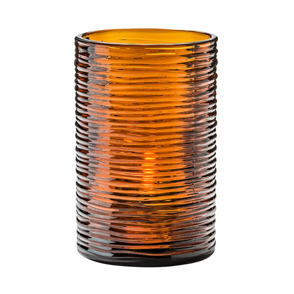 A Typhoon dark amber glass cylinder candle holder with a wavy design.