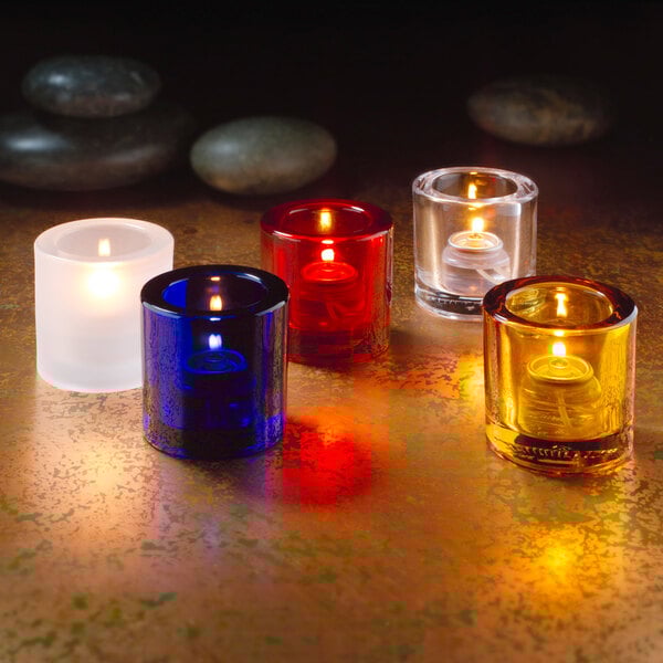 A group of Hollowick ruby glass tealight candles on a table.