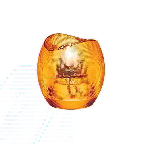A close-up of a Hollowick Pixel amber glass tealight holder with a lit candle in it.