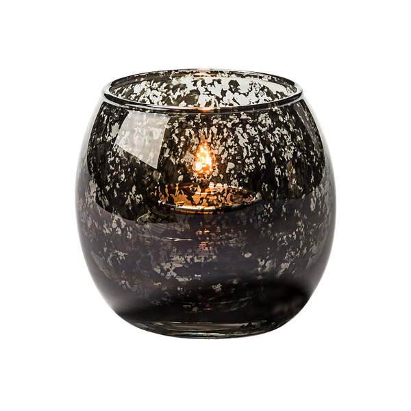 a candle in a glass container