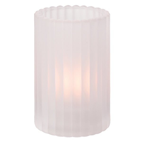 A clear glass Hollowick crystal cylinder candle holder with a light inside.