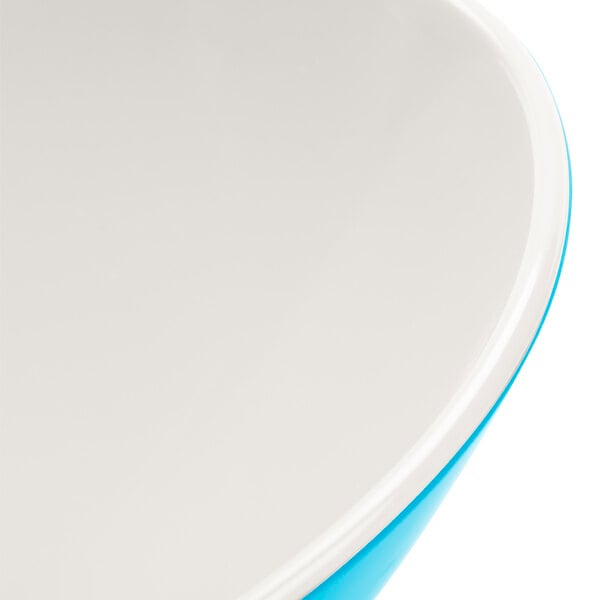 A white melamine bowl with a blue Seabreeze design and white rim.