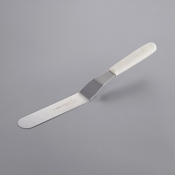 A Dexter-Russell baking/icing spatula with a white plastic handle.