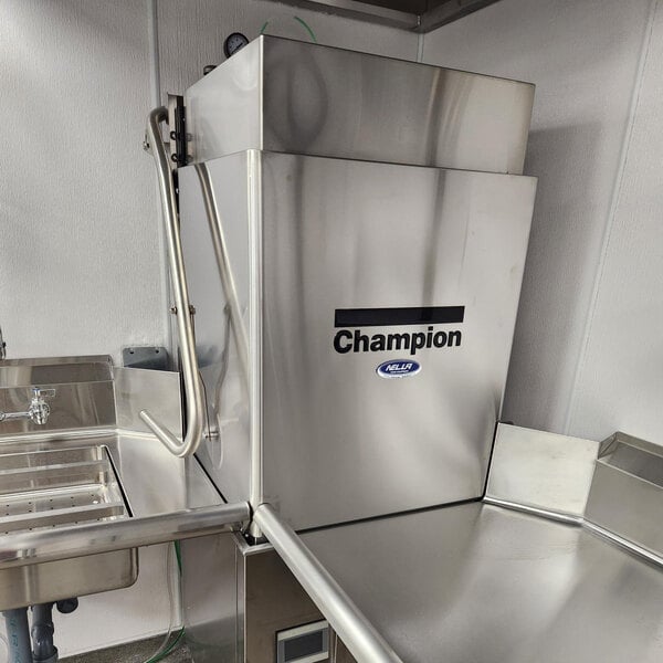 A commercial stainless steel door-type high temperature tall hood dishwashing machine with a booster heater.