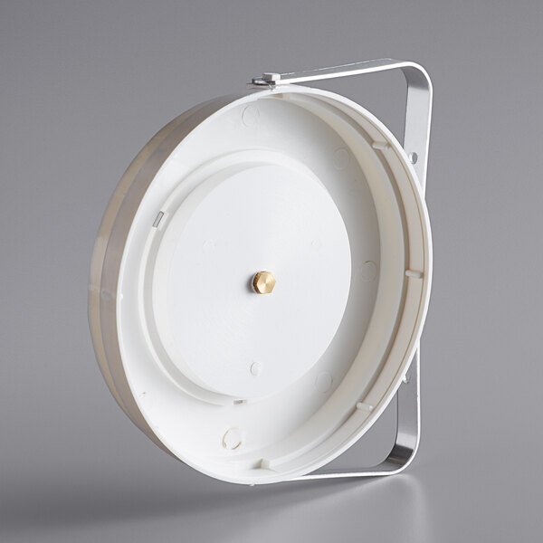 A white round object with a metal handle.