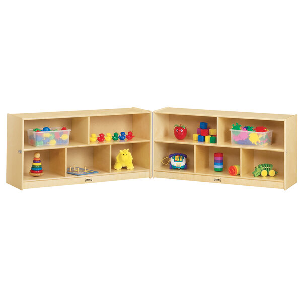 A Jonti-Craft wooden storage cabinet with 10 cubbies filled with toys.