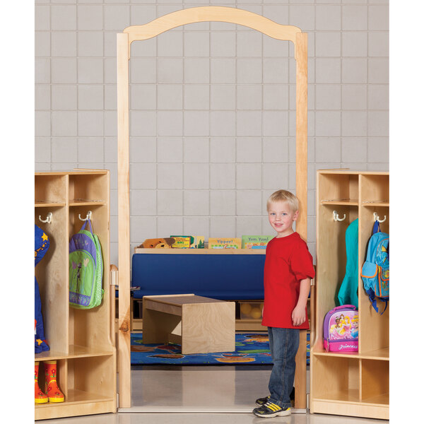 A child standing in front of a KYDZ Suite tall welcome arch.