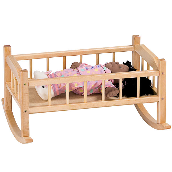 A doll in a Jonti-Craft wooden crib.