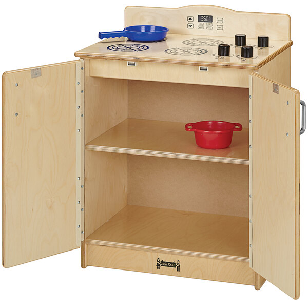 A Jonti-Craft wooden toy kitchen stove with pans on top.