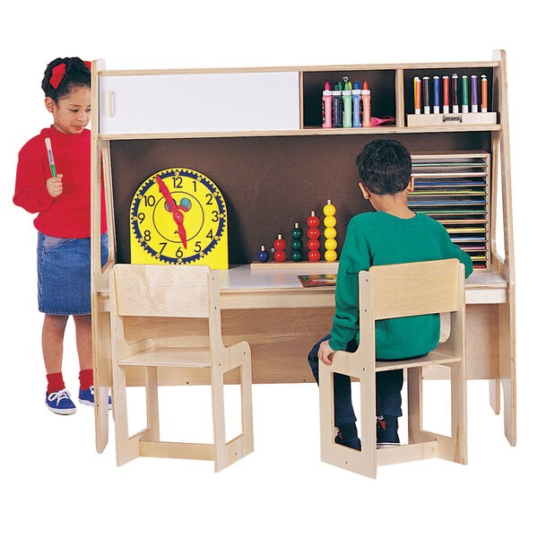 Two children using a Jonti-Craft wood twin activity center with chairs.