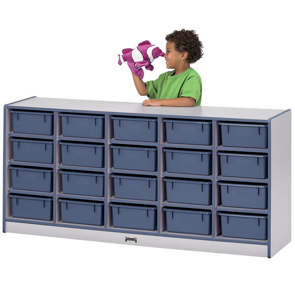 A child standing in front of a navy blue Rainbow Accents classroom storage cabinet.
