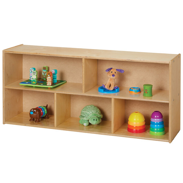 A Young Time natural wooden toddler storage unit with toys on it.