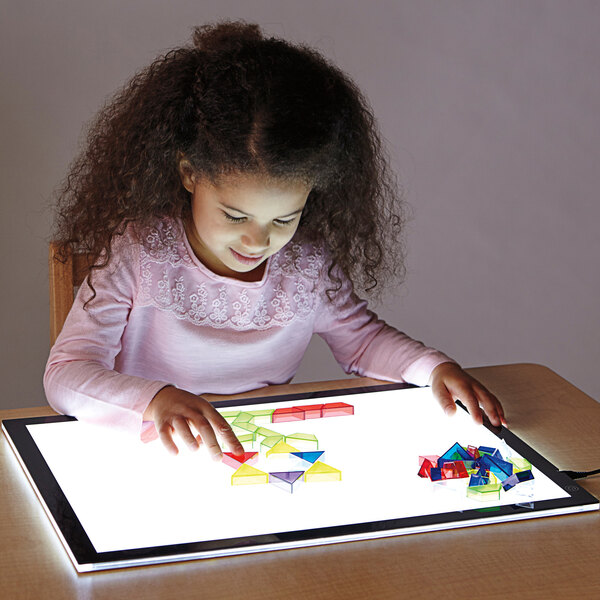 A girl using a Jonti-Craft light up tablet.