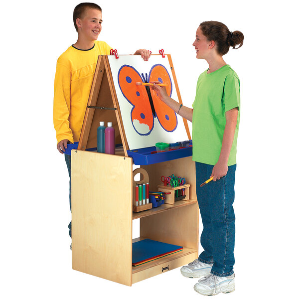 A boy and girl drawing on a Jonti-Craft School Age Art Center.