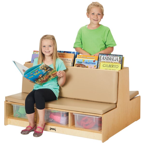 A young boy and girl sitting on a Jonti-Craft double-sided wood couch with books.