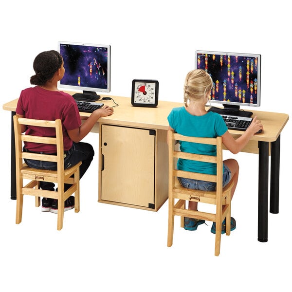 Two children sitting at a Jonti-Craft dual computer lab table with monitors.