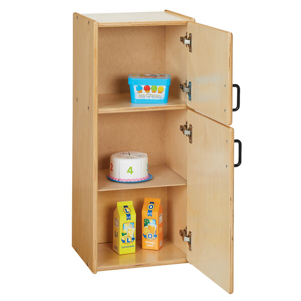 A Young Time natural wooden play refrigerator with a cake and milk carton inside.