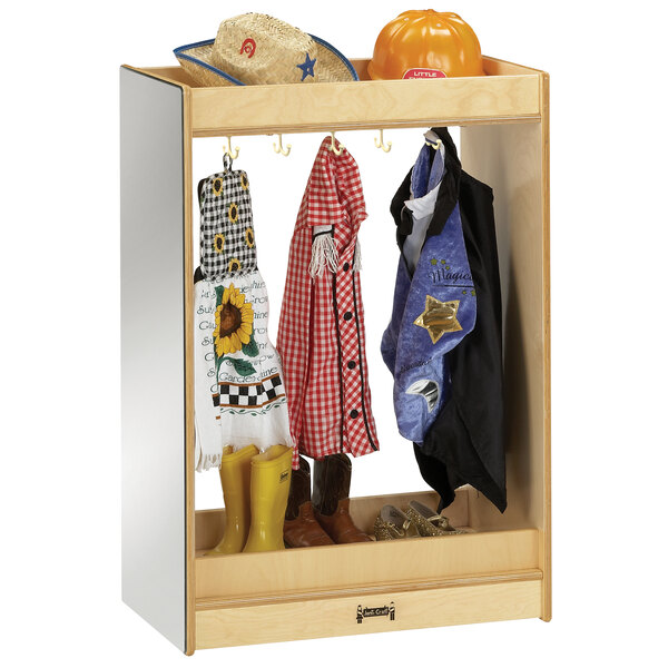 A Jonti-Craft small wooden dress-up island with clothes and boots on shelves.