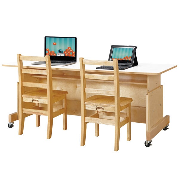 A Jonti-Craft double computer desk with two laptops on it with a white laminate top and natural wood finish.