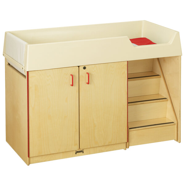 a wooden cabinet with a white and red top