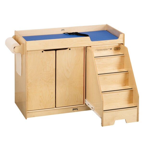 A Jonti-Craft wooden baby changing table with paper roll dispenser and safety strap.