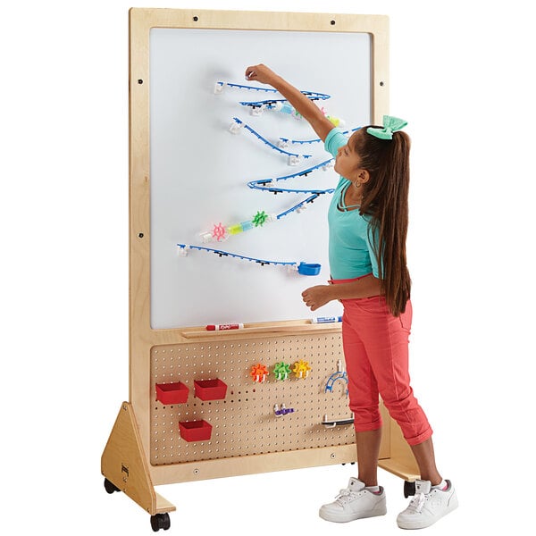 A child using a write-on stem board