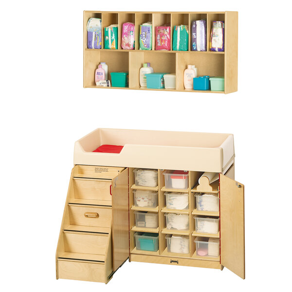 A Jonti-Craft Baltic Birch changing cabinet with shelves and cubbie trays.