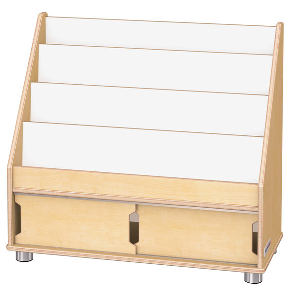 A wooden book rack with white shelves holding white paper.