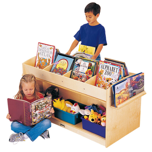 A boy and girl reading books in a Jonti-Craft wood book browser.