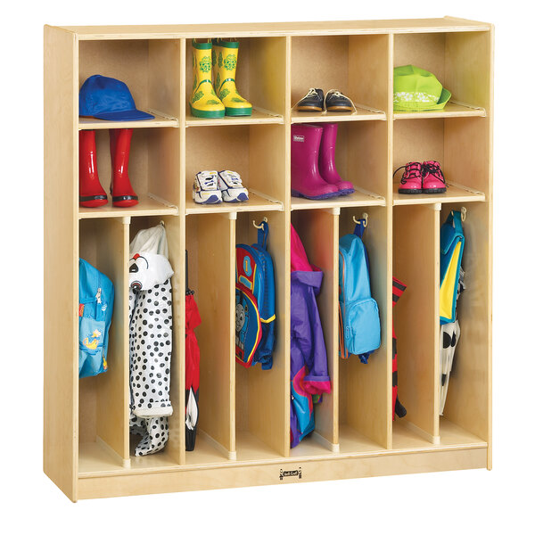 A Jonti-Craft wooden Neat-n-Trim locker with coats and boots inside.