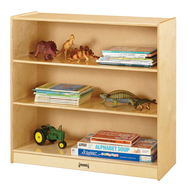 A Jonti-Craft natural wood bookcase with toys and toy dinosaurs on the shelves.