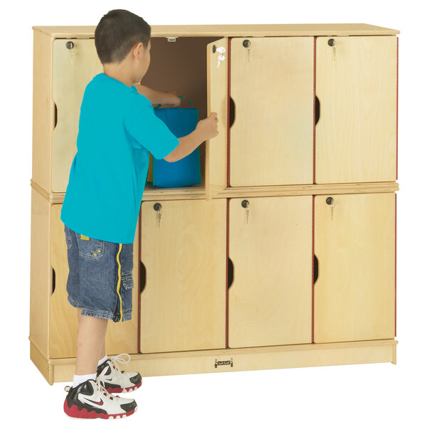 A young boy opening a Jonti-Craft double stack locker.