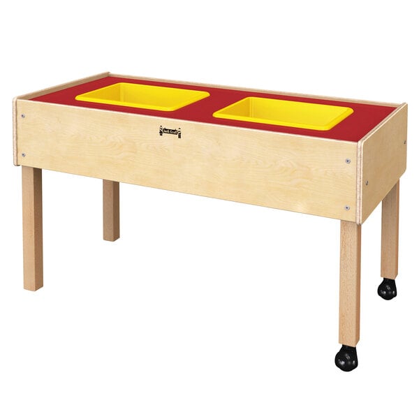 a wooden table with two rectangular yellow bowls