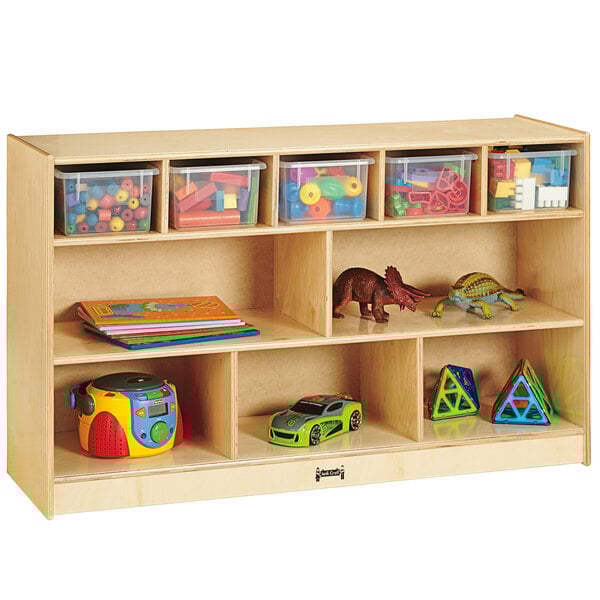 A Jonti-Craft wooden storage unit with clear plastic bins holding toys.