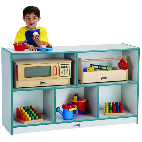 A child playing with toys in front of a Rainbow Accents teal storage cabinet.